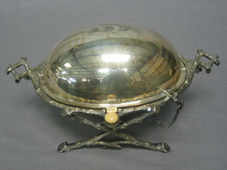 An oval silver plated breakfast dish, raised on crab stock supports 10"