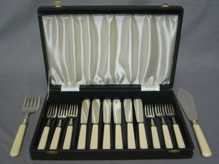 A pair of silver plated fish servers and a set of silver plated fish knives and forks cased
