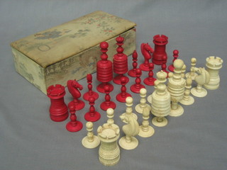 A carved red and white ivory chess set