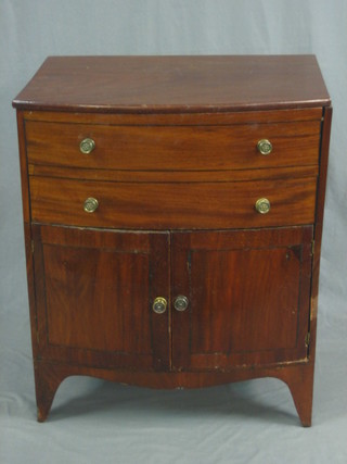 A Georgian mahogany bow front commode with hinged lid, the base fitted a cupboard enclosed by panelled doors, raised on bracket feet 23"