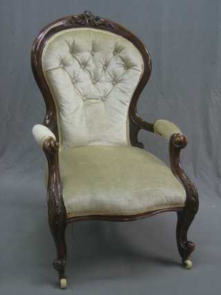 A Victorian carved mahogany show frame open arm chair, raised on cabriole supports
