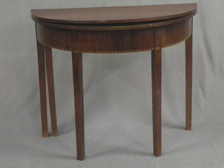 A 19th Century mahogany demi-lune tea table with ebony and satinwood decoration, raised on square supports 36"