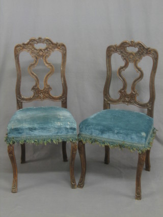 A pair of 18th/19th Century French walnut chairs with pierced vase shaped splat backs and upholstered seats, raised on cabriole supports