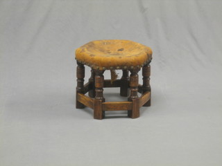 An octagonal oak stool raised on turned and block supports 15"