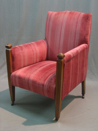 An Edwardian Art Nouveau inlaid mahogany armchair upholstered in pink material