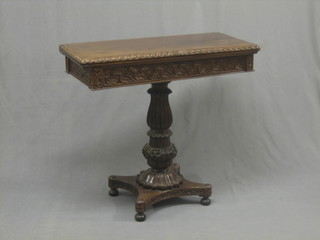 A William IV style rosewood card table with gadrooned decoration, raised on a turned column with triform base 34"