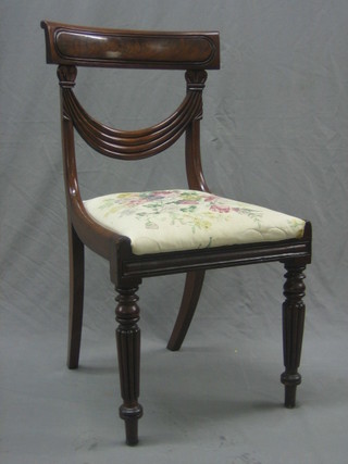 A handsome Regency mahogany bar back dining chair with swag shaped mid rail and old blacksmith repair, having a upholstered drop in seat, raised on turned and reeded supports
