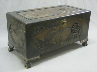 A carved Hong Kong camphor coffer with hinged lid, raised on carved supports 35"