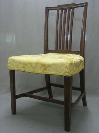 A set of 10 Georgian style mahogany stick and rail back dining chairs with upholstered seats, raised on square supports
