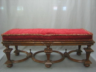 An Italian rectangular carved walnut stool (possibly the base of a cabinet) with cane work case, raised on chamfered supports with X framed stretcher 47"