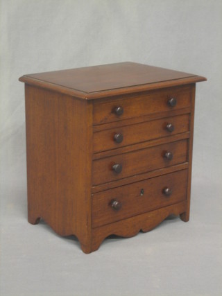 A 19th Century mahogany apprentice chest of 4 long drawers with tore handles, raised on bracket feet 10"