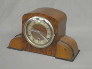 An Art Deco 8 day chiming mantel clock contained in a walnut case