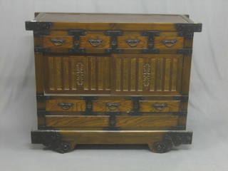 A Japanese hardwood cabinet fitted 4 drawers above a cupboard enclosed by sliding panelled doors, the base fitted 3 short drawers above 2 long drawers 46"
