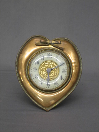 A 19th Century table clock with enamelled dial and Arabic numerals contained in a brass heart shaped case