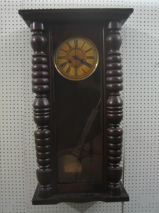 A Vienna style regulator with 7" circular paper dial and Roman numerals, contained in a walnut case with grid iron pendulum