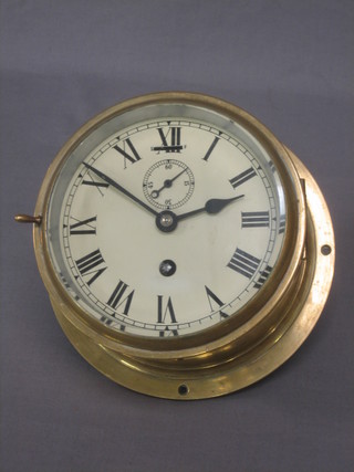 A Ward Room style clock with 6" painted dial with Roman numerals, contained in a brass case