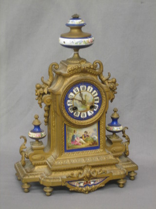 A 19th Century French striking clock contained in a gilt painted metal and porcelain case, surmounted by an urn (f)