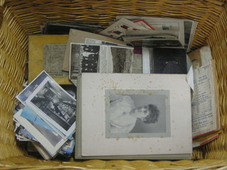 A  rectangular wicker basket containing a collection of ephemera, postcards etc