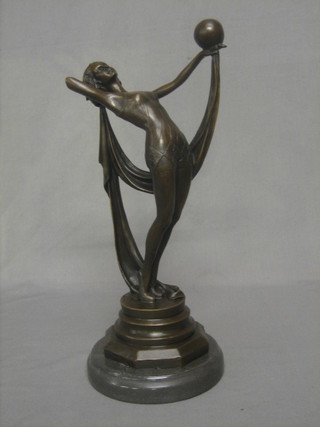A reproduction Art Deco bronze figure of a standing girl balancing a ball 15"