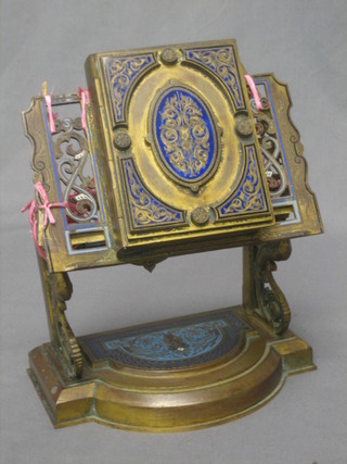 A  19th Century gilt metal and champ nouveau enamelled bible or triptych frame, raised on a gilt metal base 7" (requires some attention)