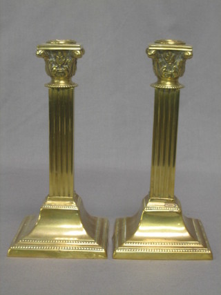 A pair of square brass reeded candlesticks with Corinthian capitals 9"