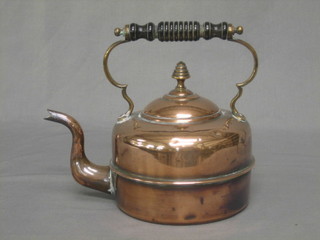 A Victorian copper kettle with ebony handle