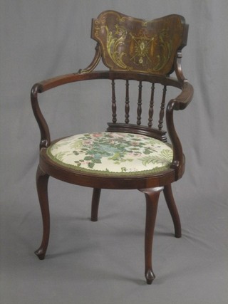 An Edwardian inlaid mahogany tub back carver chair with spindle decoration, raised on cabriole supports