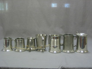 A lidded pewter tankard and 6 others