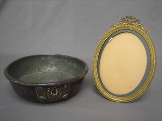A gilt metal easel photograph frame surmounted by a garland 10" and a circular copper dish 10"