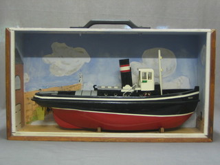 A wooden battery operated model of a Tug 23", contained in a wooden carrying case