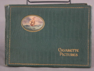 A green album of various black and white cigarette cards