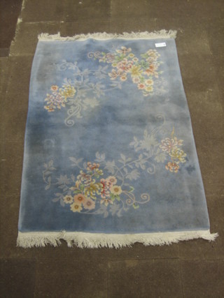 A Chinese blue ground and floral patterned rug 78" x 56"