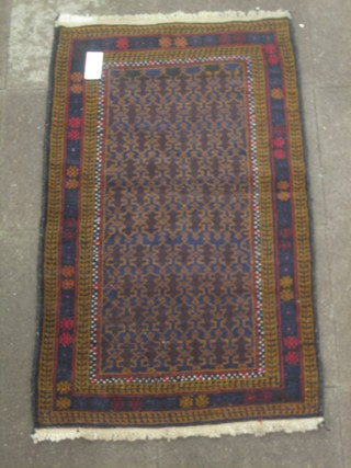 A contemporary blue and brown ground Belouch rug with all over geometric design 54" x 32"