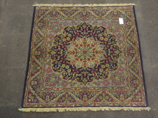A contemporary Persian blue ground rug with central rose medallions 58" x 57"