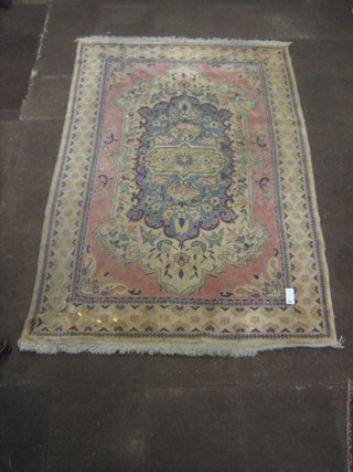 A  machine made white and pink ground Eastern style carpet 107" x 72"