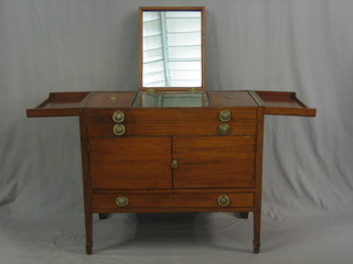 A 19th Century Continental mahogany enclosed wash stand, the hinged lid revealing a hinged mirror and 2 fitted compartments above a cupboard, the base fitted a drawer and raised on square tapering supports ending in spade feet 33"