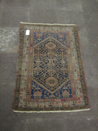 An Eastern blue ground rug with all-over geometric design 62" x 41" (some wear)