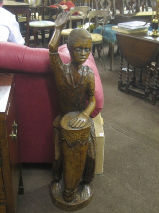 A large carved Eastern figure of a native drummer 42"
