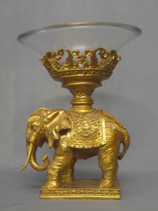 A gilt plaster table centre piece in the form of an elephant supporting a glass bowl 18"