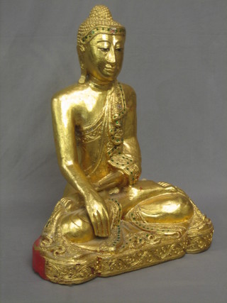 A gilt painted figure of a seated Buddha 20"