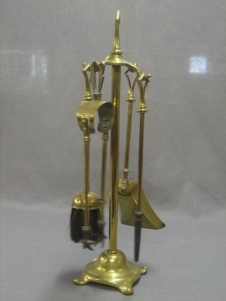 A brass 4 piece fireside companion set