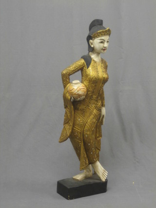 A carved Eastern gilt painted and ball studded figure of a standing lady 41"