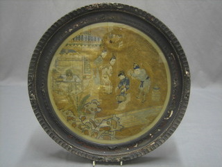 A circular Eastern embroidered panel depicting courtly figures 14" contained in a carved frame