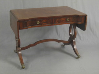 A Georgian style shaped mahogany sofa table, fitted 2 long drawers, raised on lyre supports 39"
