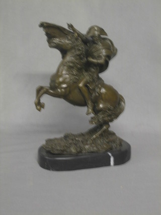 A bronze figure of Napoleon riding a rearing horse, raised on a marble base 13"