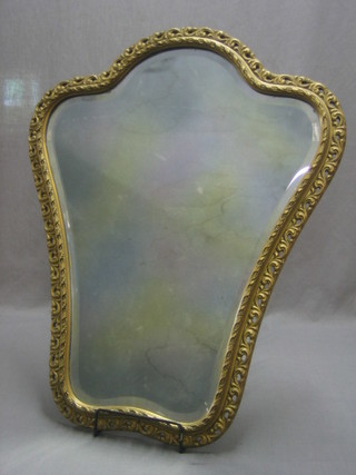 A pair of shaped bevelled plate mirrors contained in decorative gilt frames 27"