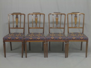 A set of 4 Edwardian inlaid mahogany stick and rail back dining chairs, raised on square tapering supports