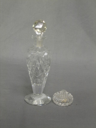 A circular cut glass scent bottle with hobnail cut decoration 2" and a waisted cut glass scent bottle with stopper 6 1/2"