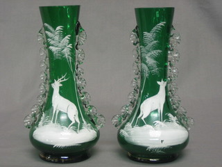A pair of Victorian green glass and white enamel overlay vases decorated deers, 7"