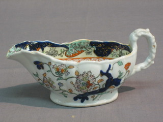 A Masons ironstone Imari pattern sauce boat, the base with black Masons mark and marked Higginbotham & Sons of Dublin 7" (chipped and cracked)
